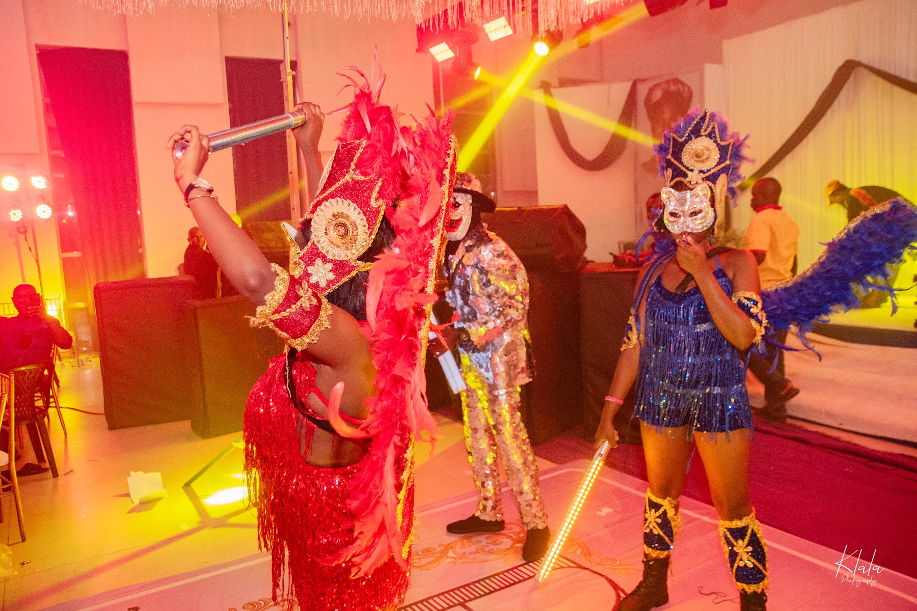 Birthday party performers in red lighting