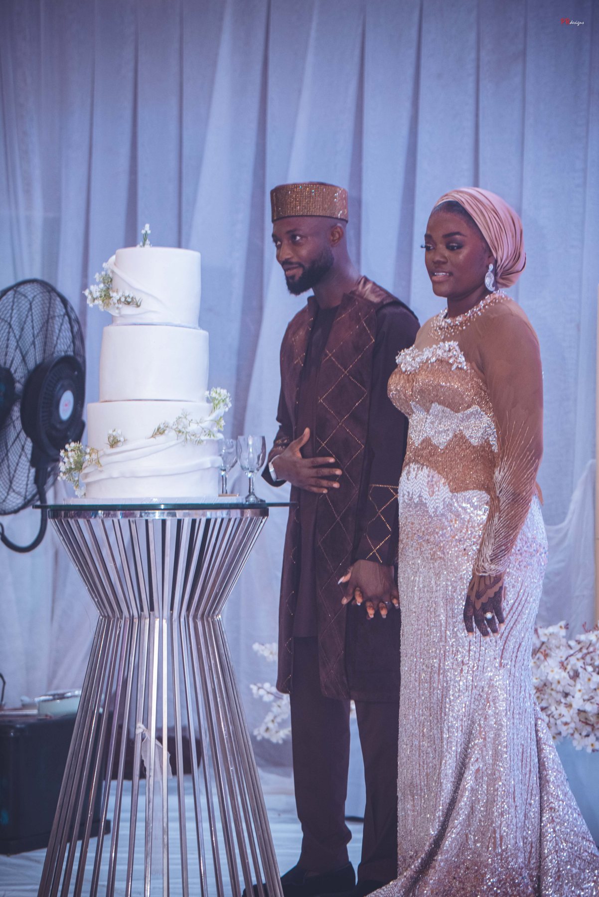 Couple beside wedding cake