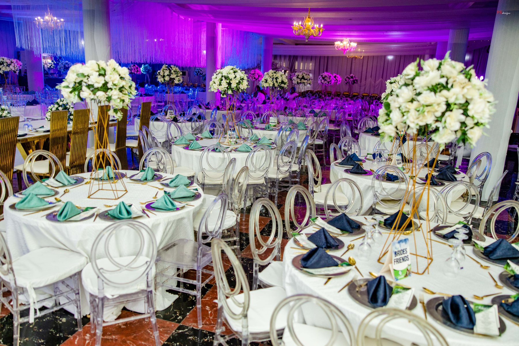 Reception hall with purple lighting and table settings